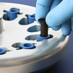 Scientist Placing a Test Tube in Centrifuge in the Lab